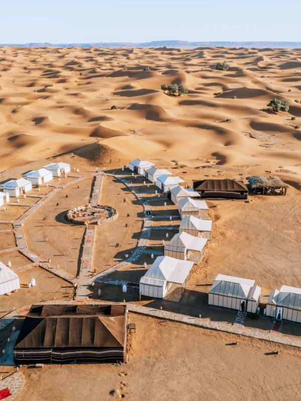Couple riding a camel during the 4-day program from Marrakech to the Merzouga desert at sunset